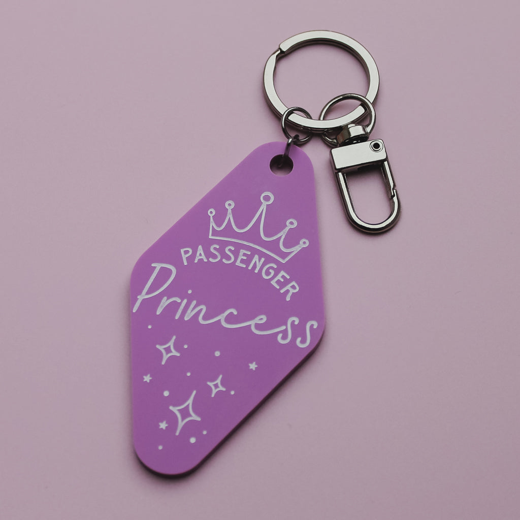 Pink motel style keyring with 'Passenger Princess' text on a pink background