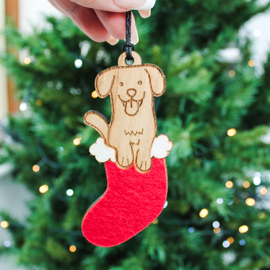 Wooden cute dog ornament in a Christmas stocking, a festive Christmas tree decoration and gift for dog lovers.