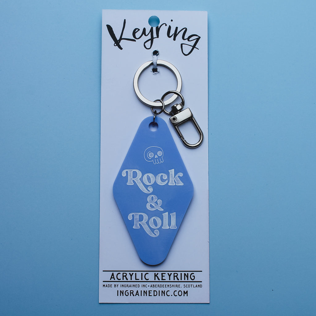 Blue acrylic Motel style keyring with 'Rock & Roll' text on a matching backing card against a blue background