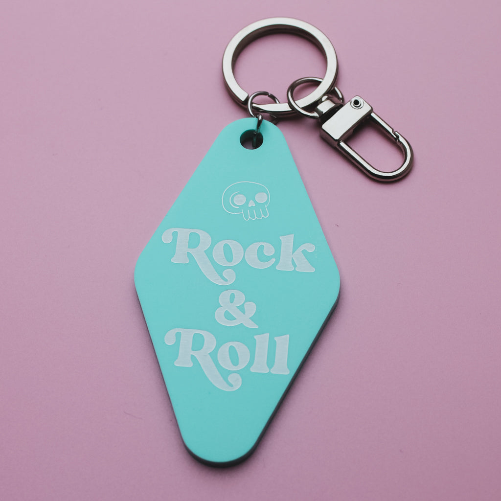 Mint coloured Motel style keychain with 'Rock & Roll' text on a pink background