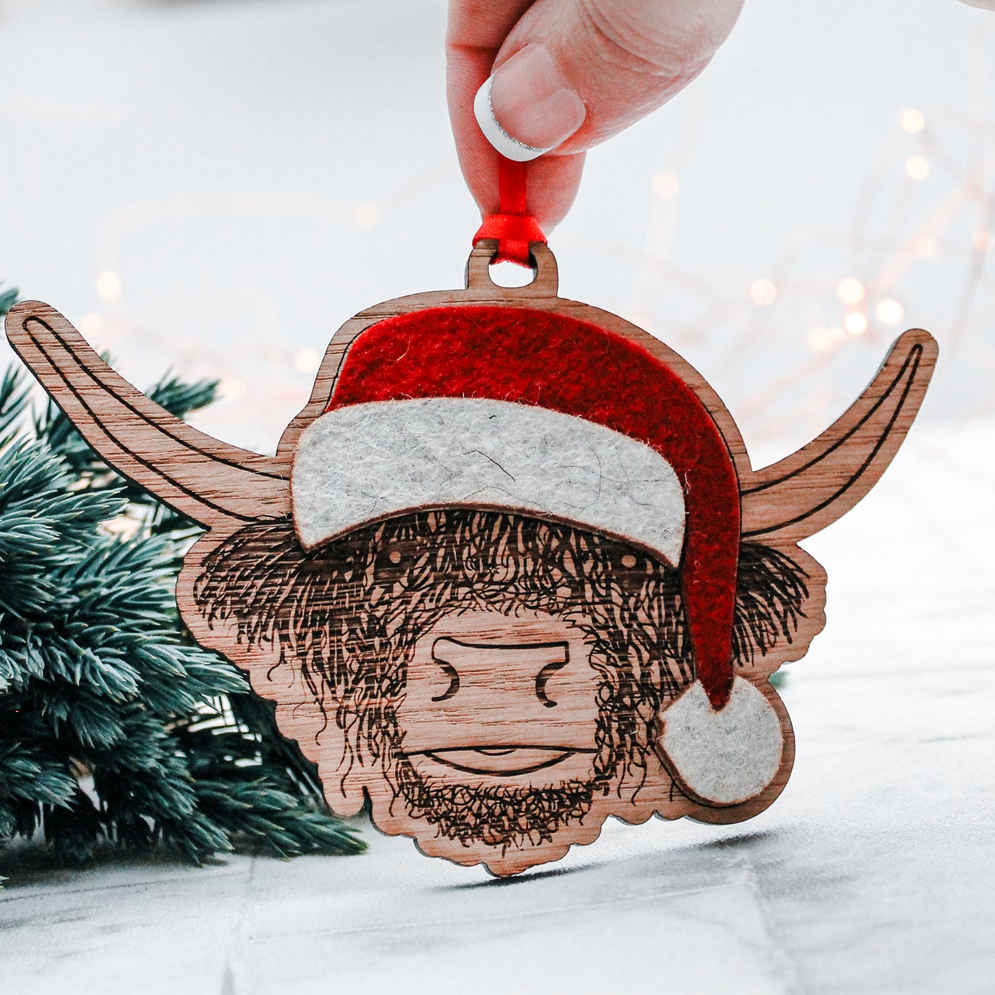 wooden Scottish highland cow Christmas tree decoration with felt Santa hat