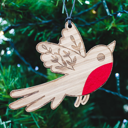 Wooden robin decoration with a red breast on a Christmas tree.