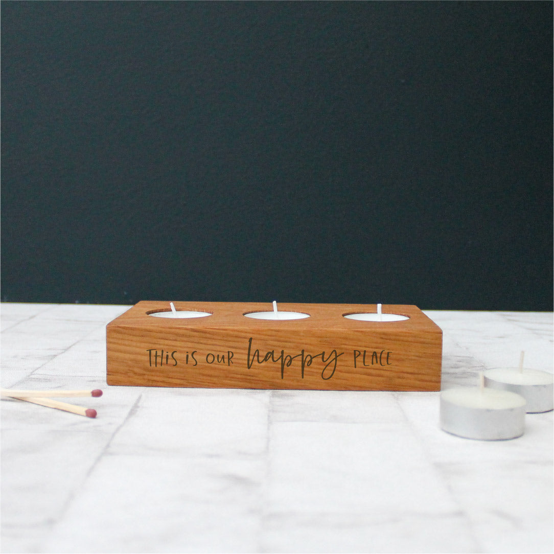 chunky wooden solid oak tealight holder engraved with the phrase this is our happy place on the side