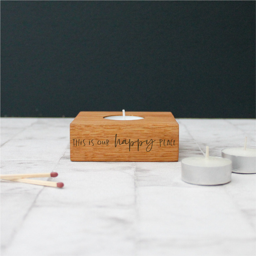 chunky wooden solid oak single square tealight holder engraved with the phrase this is our happy place on the side