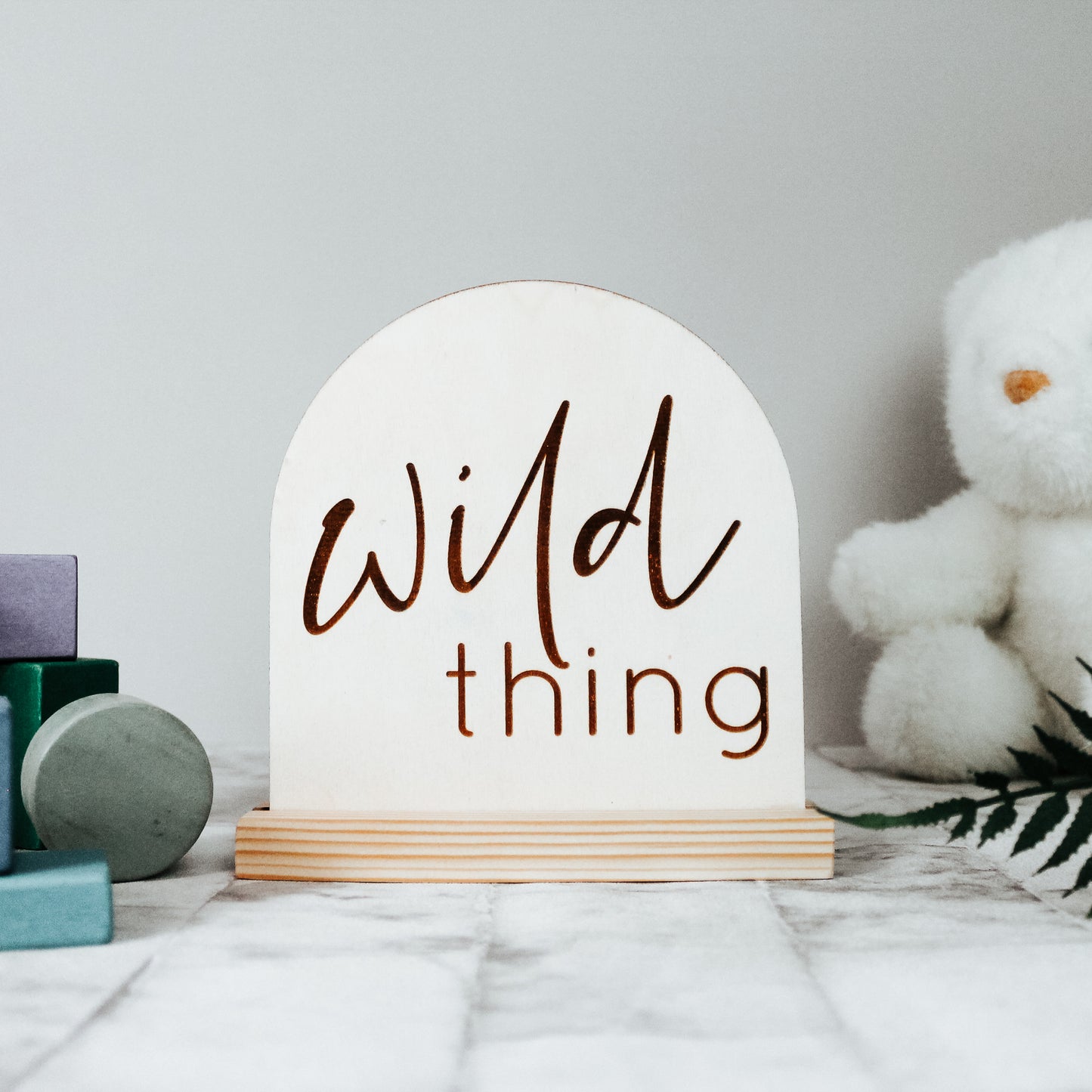 natural wooden sign for kids room, engraved with the phrase wild thing in a modern font 