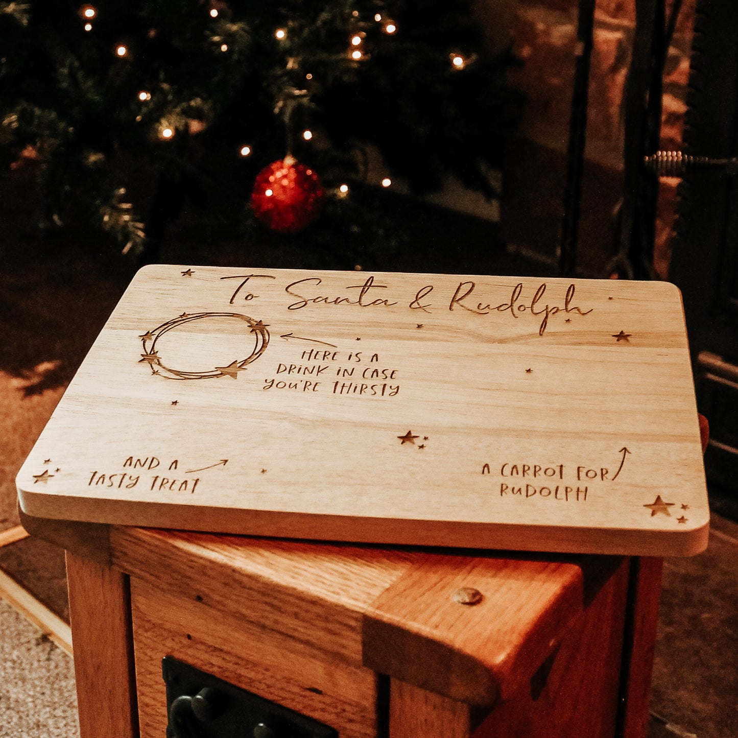 wooden christmas eve plate for santa and the reindeer with space for a drink, carrots for the reindeer and a tasty treat