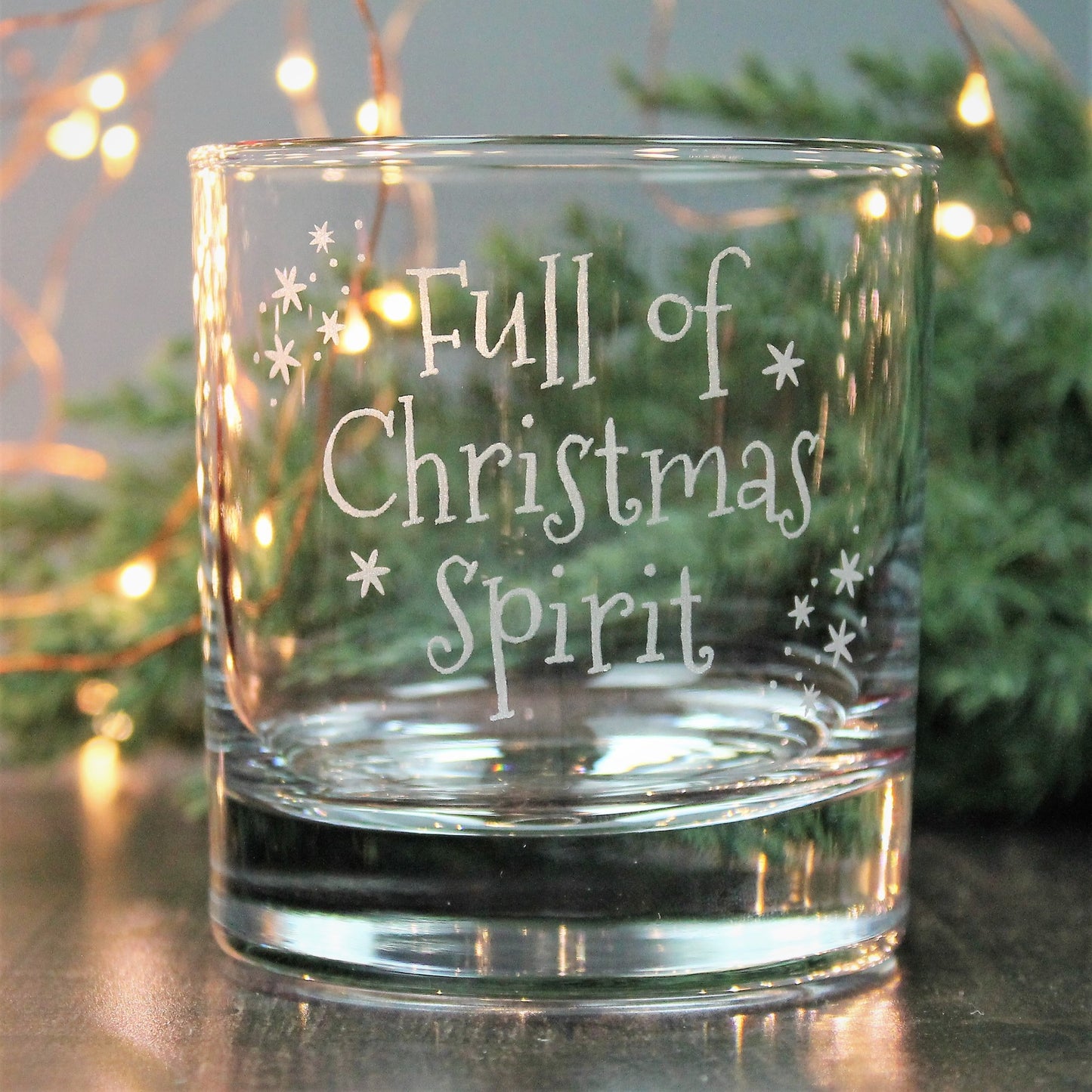 Whisky tumbler glass engraved with the words - full of Christmas spirit.