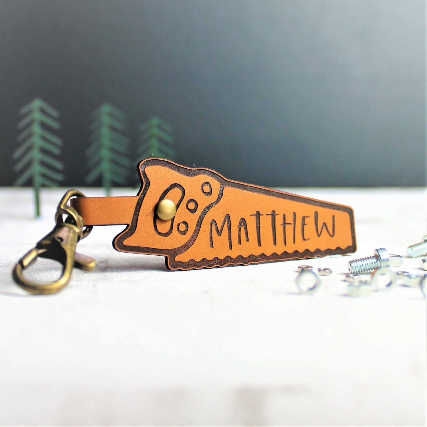 Saw shaped engraved leather keyring with brass clasp