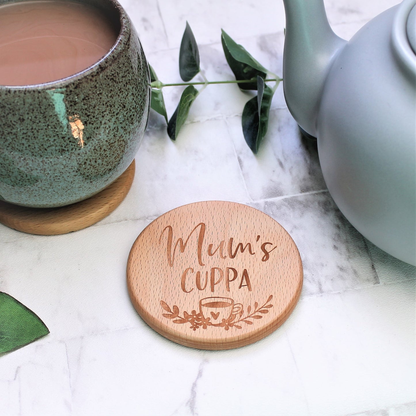 engraved wooden caoster for tea loving mum, engraved with the text mums cuppa with a floral design and tea cup 