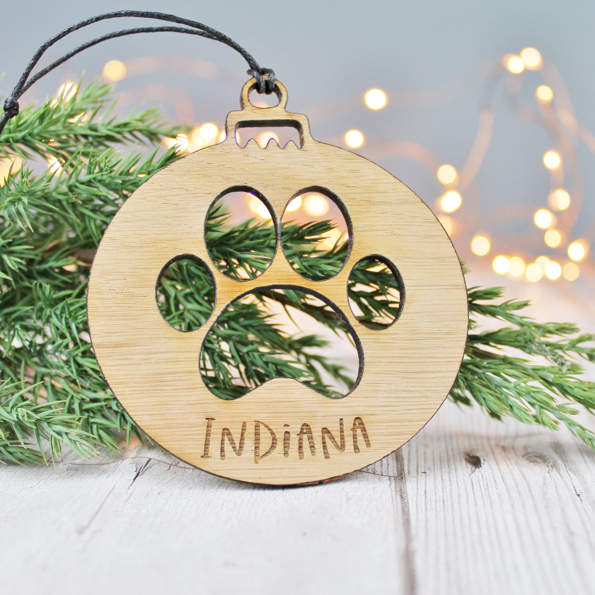 engraved personalised dog memorial wooden Christmas tree decoration with paw print design cut out 