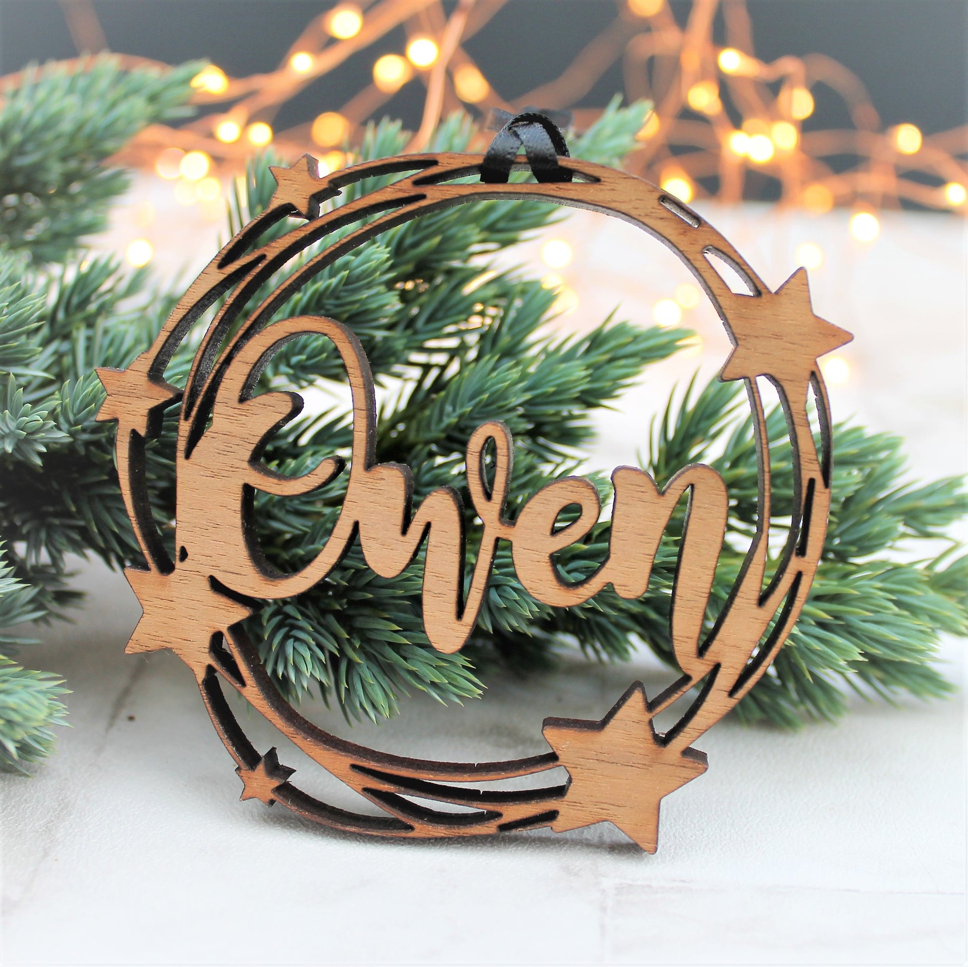 wooden personalised name bauble with star decoration, with a cut out design