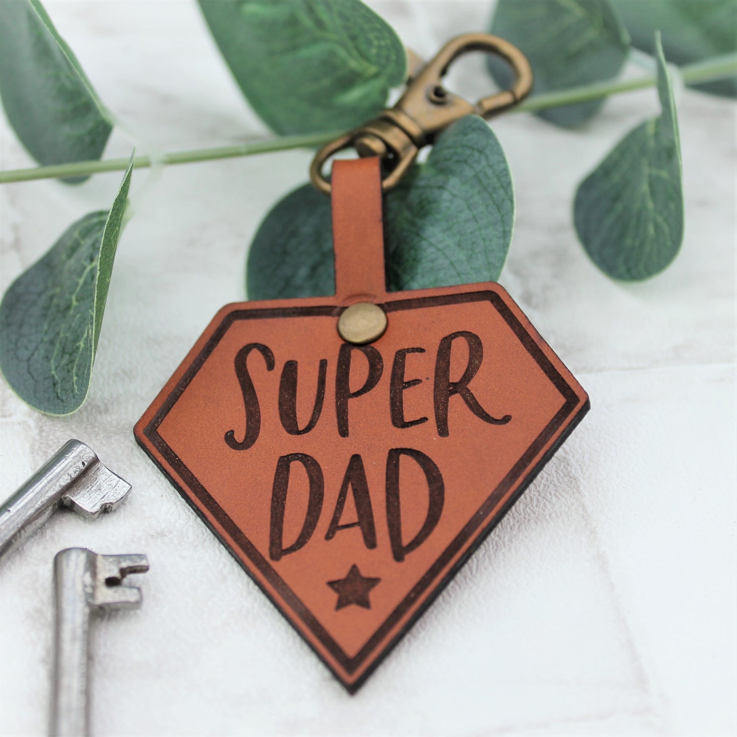 Leather tan keyring with text saying super dad on it 