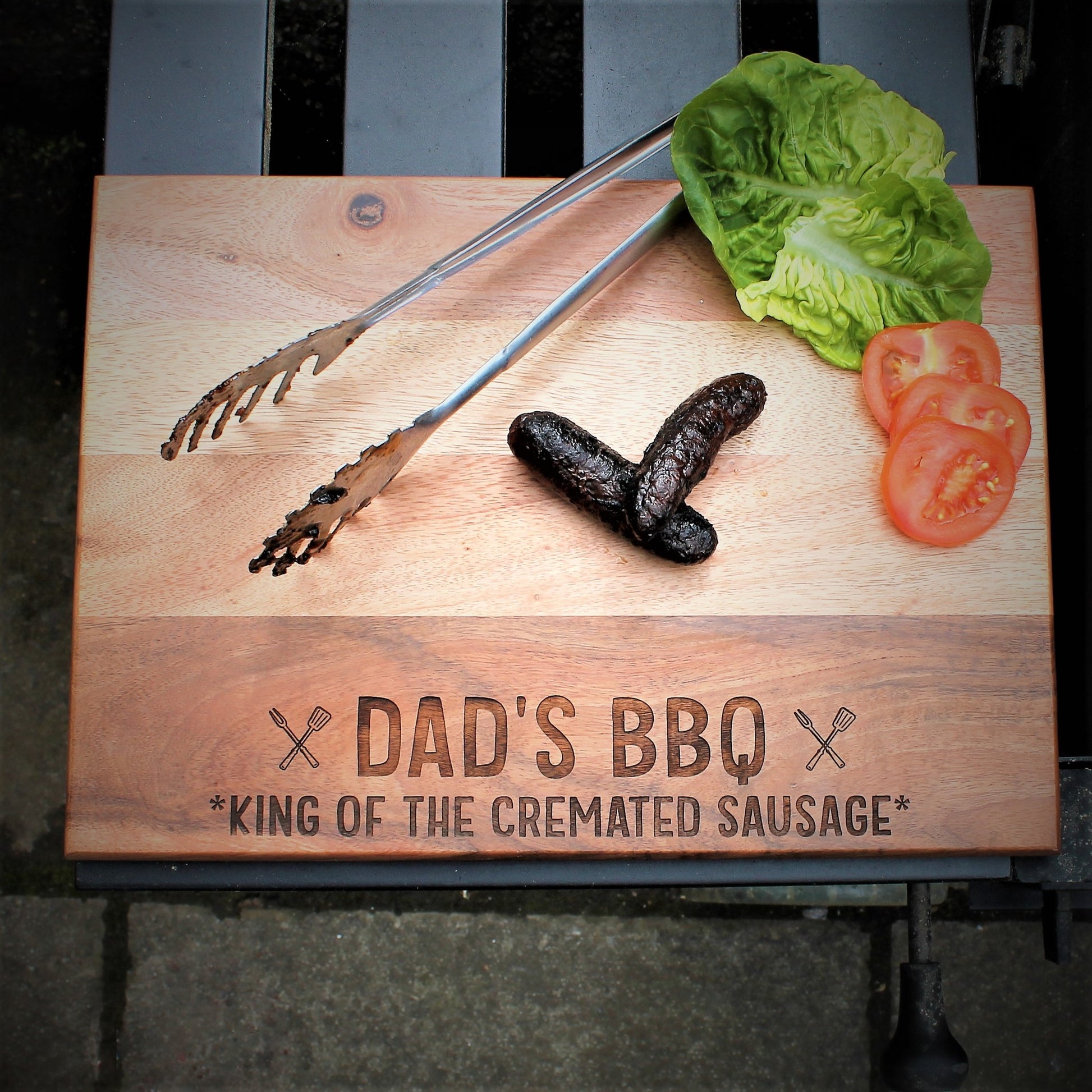 wooden chopping bbq board engraved with the words dad's bbq