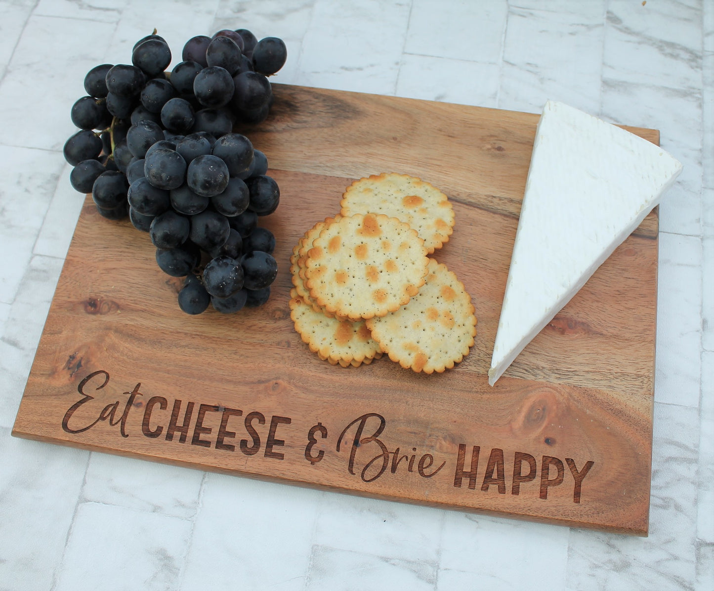 Wooden engraved chopping board with the words eat cheese and brie happy