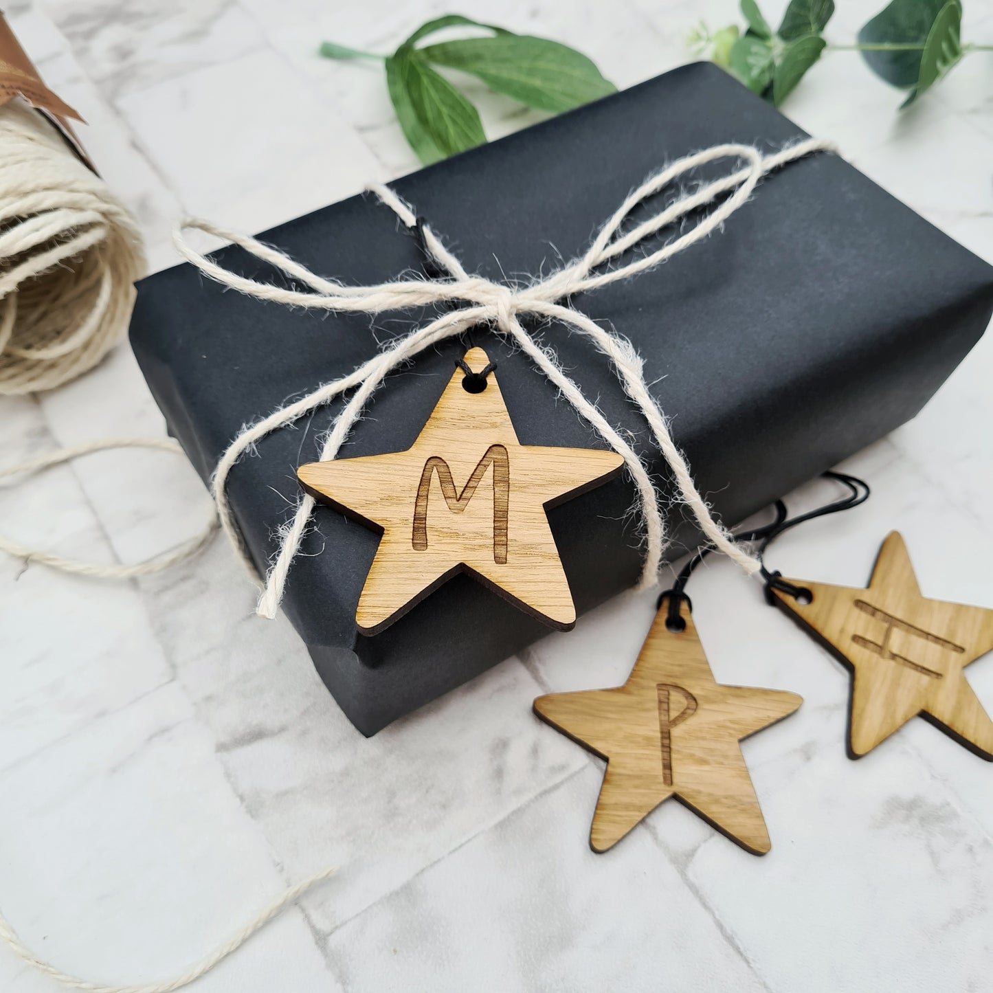 Star shaped gift tags engraved with the initial of your choice can also be used as decoration too 