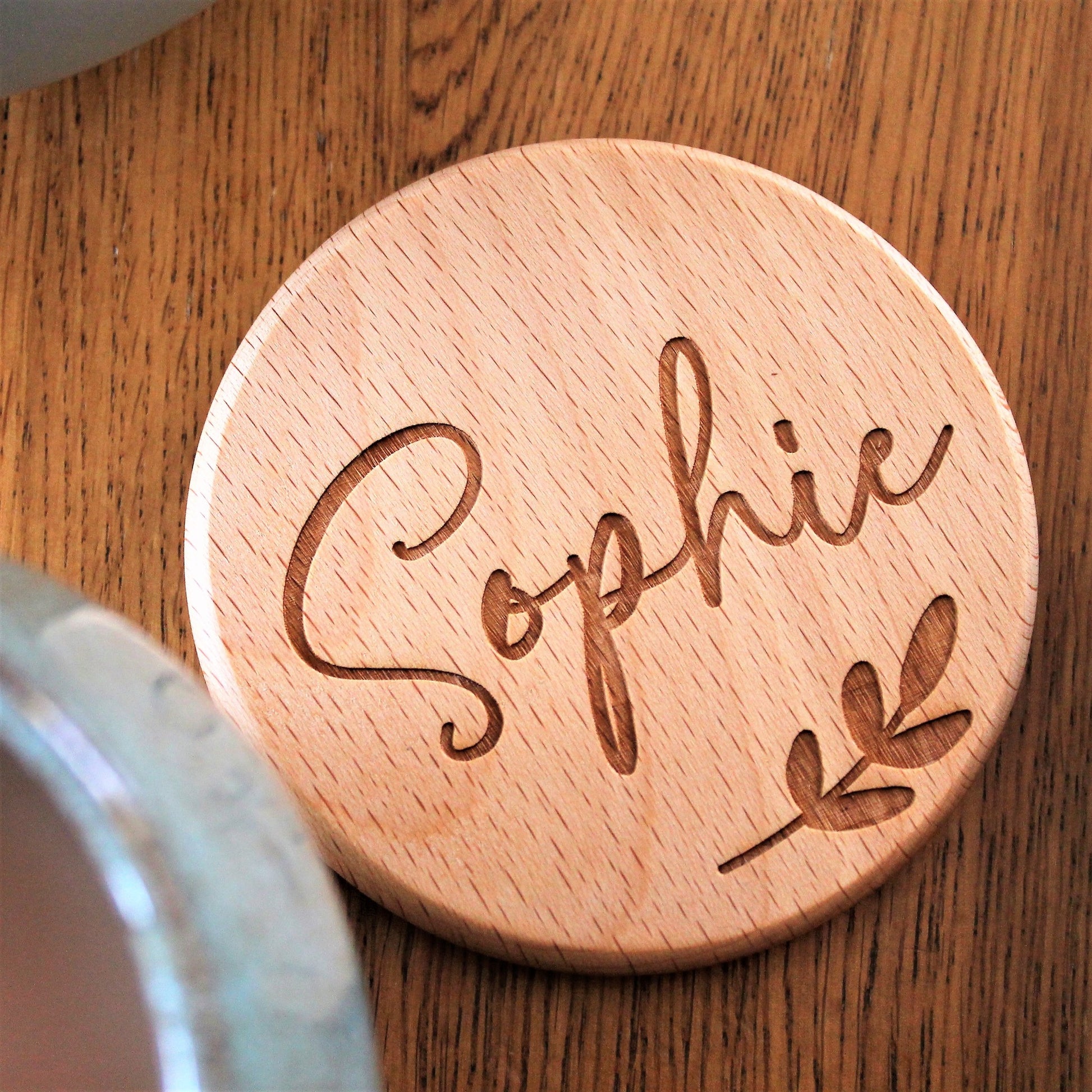 wooden coaster with engraved name and leaf design