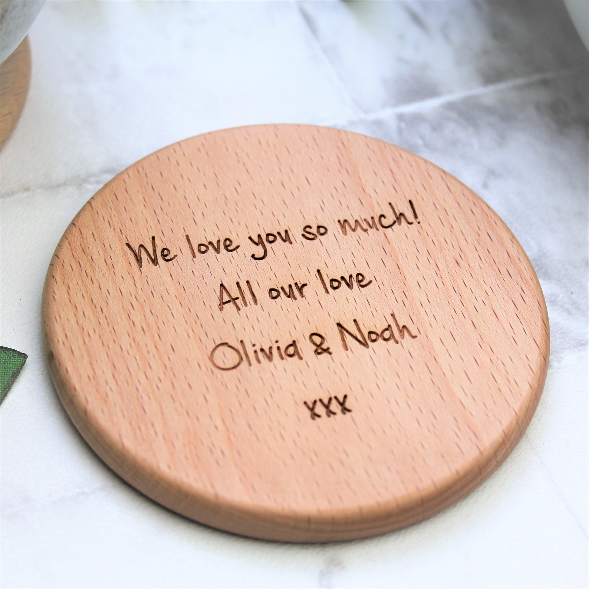 reverse text of a round wooden coaster engraved with personalised message 