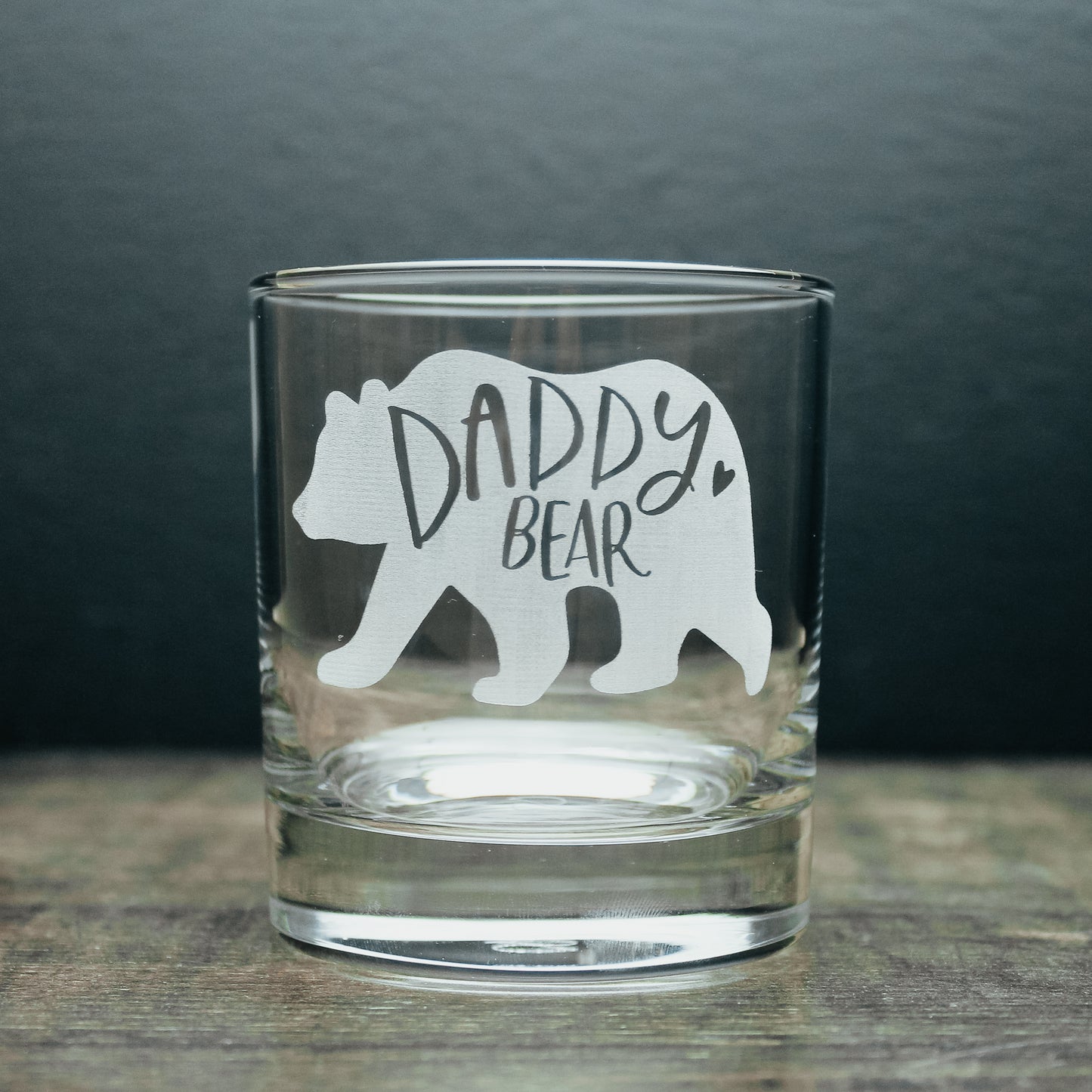 glass tumbler with a white engraved bear on it. Engraved with the wording daddy bear inside of the bear design 