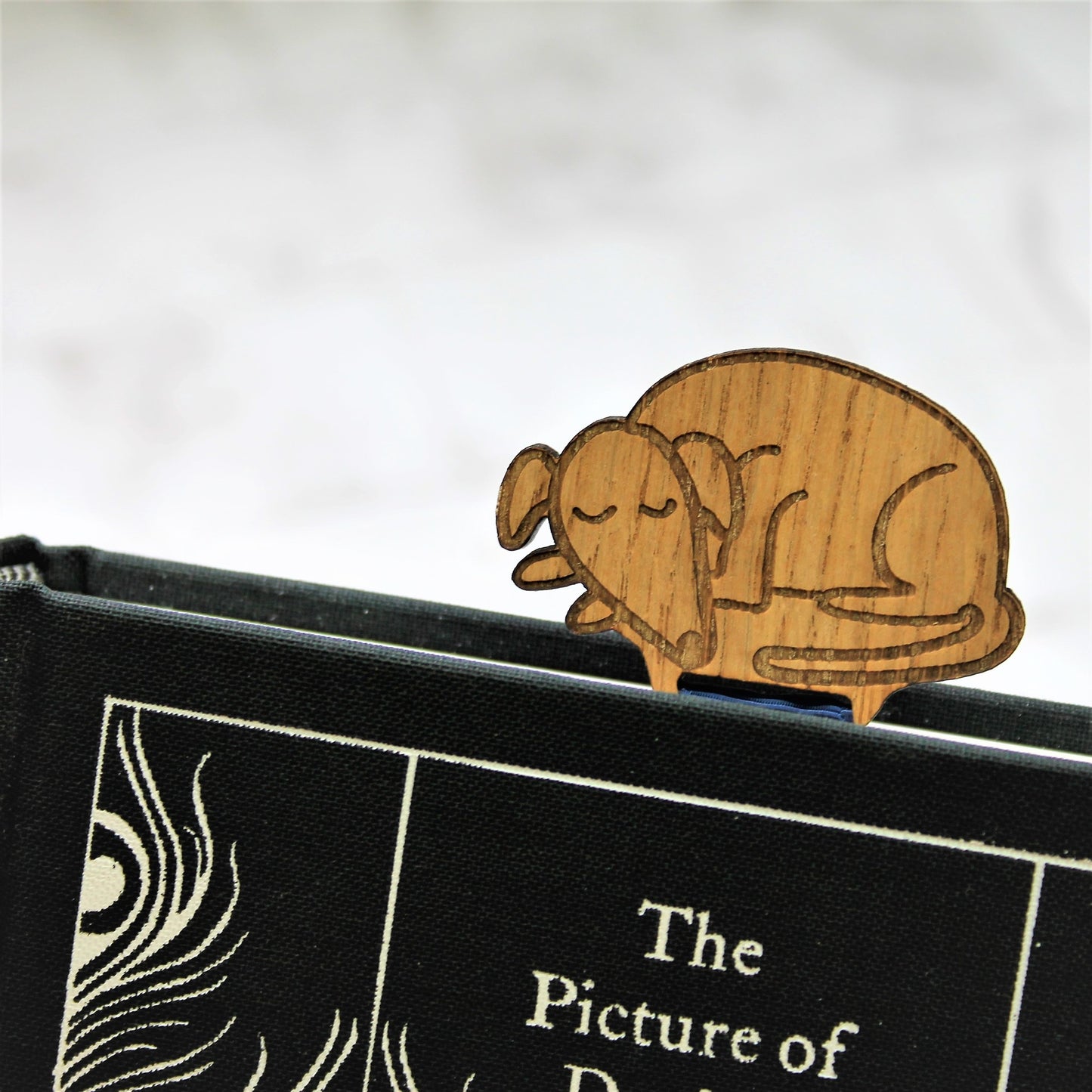 sleeping dog bookmark made from wood and ribbon 