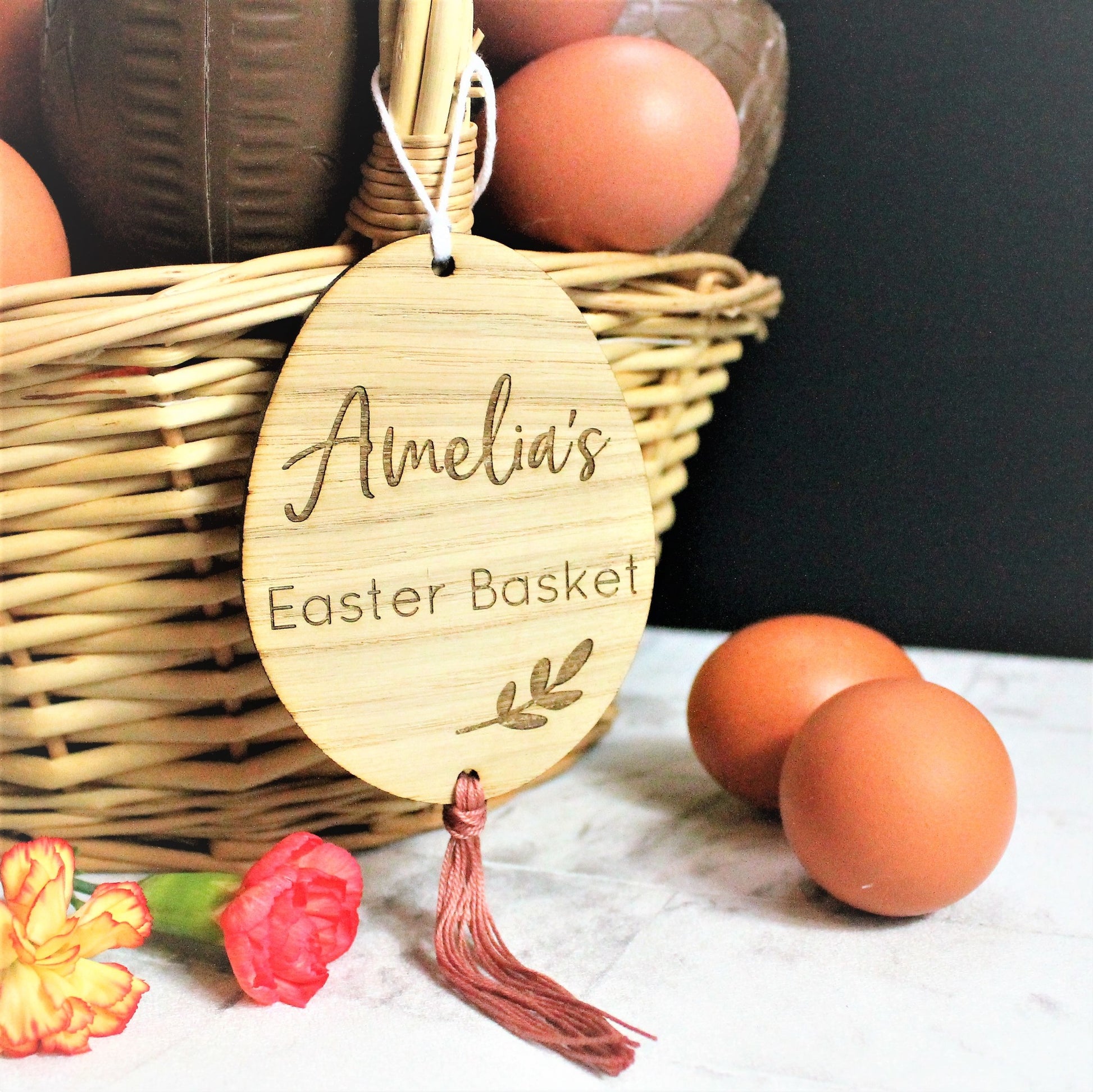 wooden egg shaped engraved tag with personalised name for an easter basket