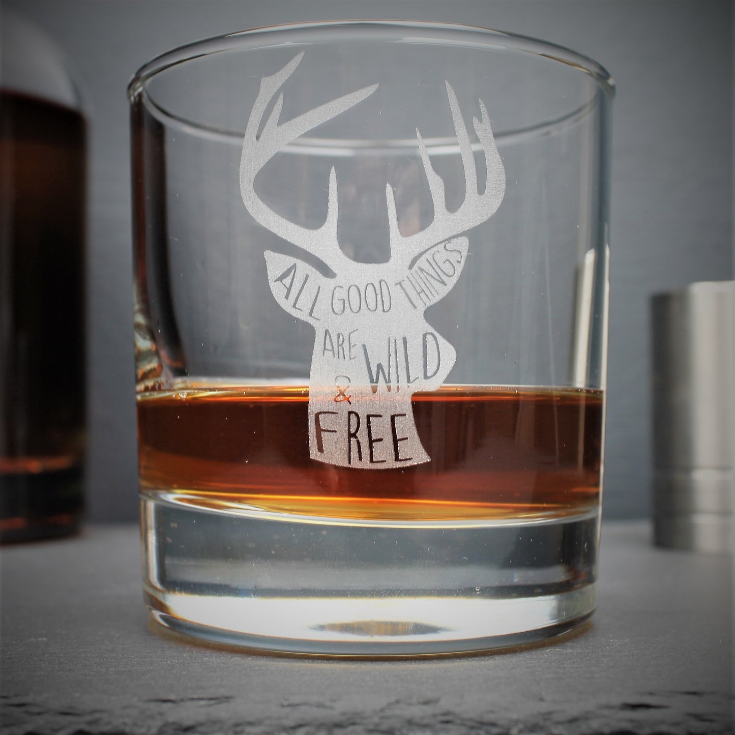 Engraved whisky tumbler glass with stag design and quote