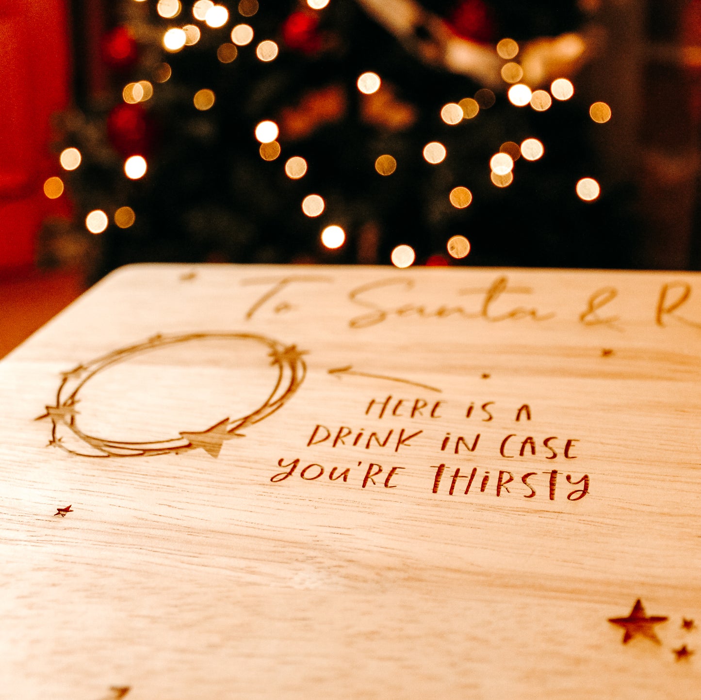wooden christmas eve plate for santa and the reindeer with space for a drink, carrots for the reindeer and a tasty treat