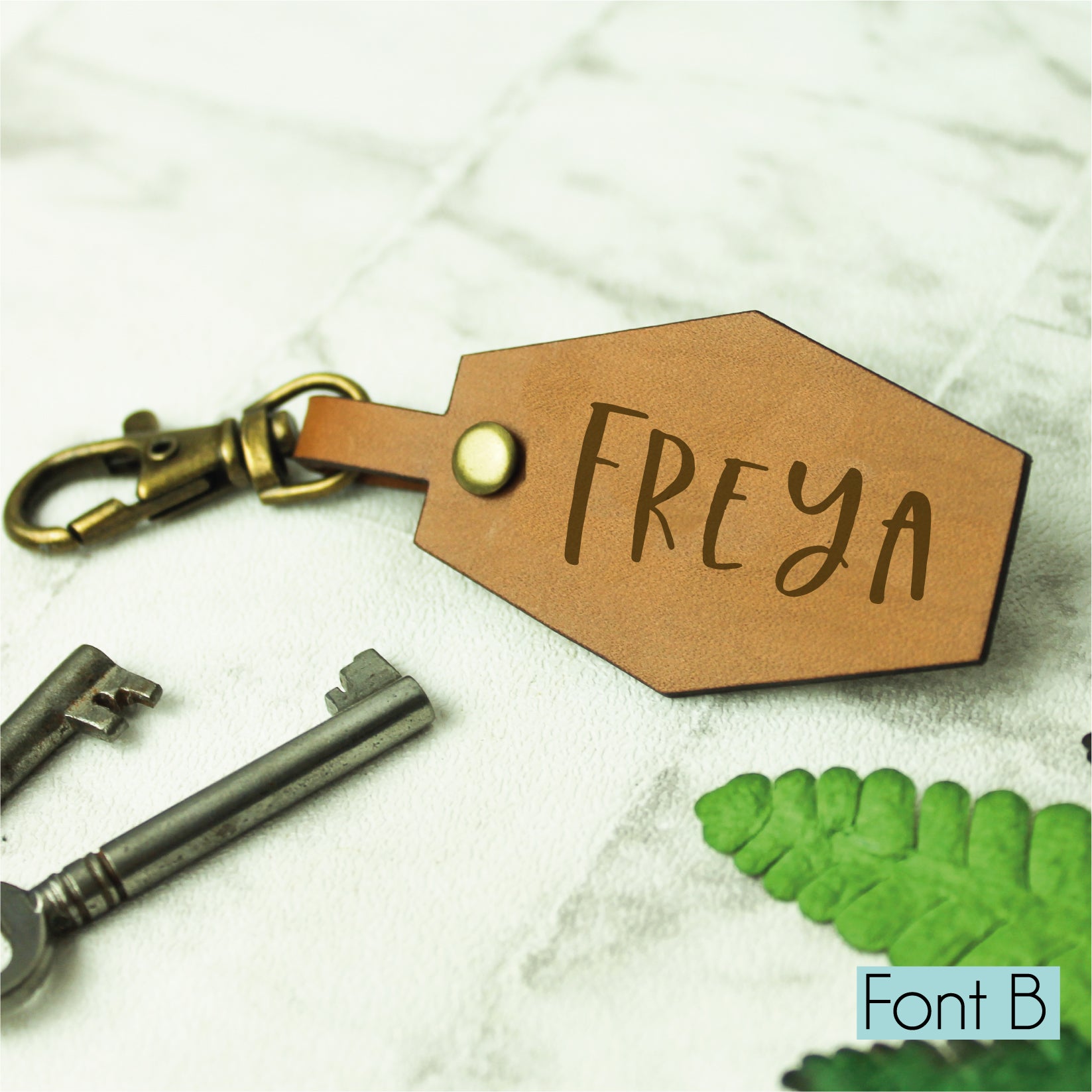 personalised name keyring engraved on a whisky coloured brown leather affixed to a swivel clasp