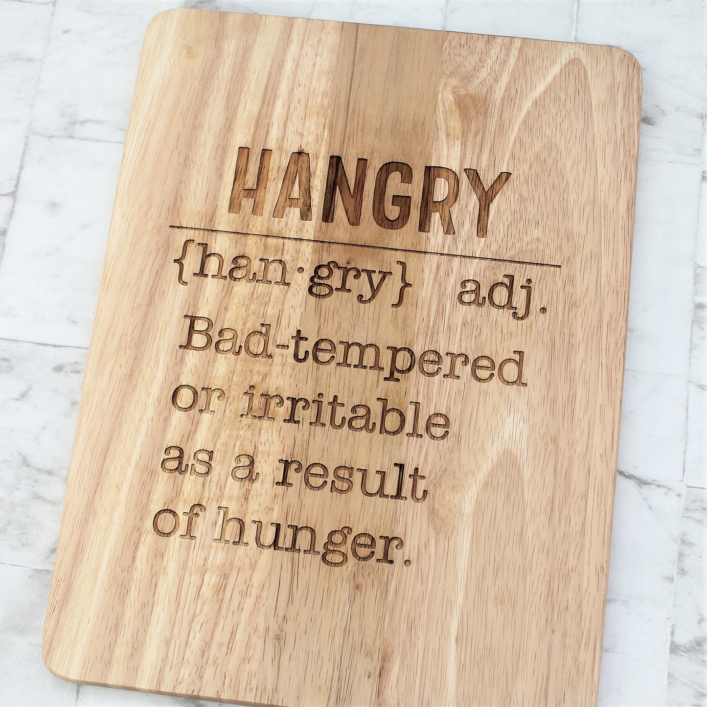Wooden engraved chopping board with the definition of hangry etched into  it 