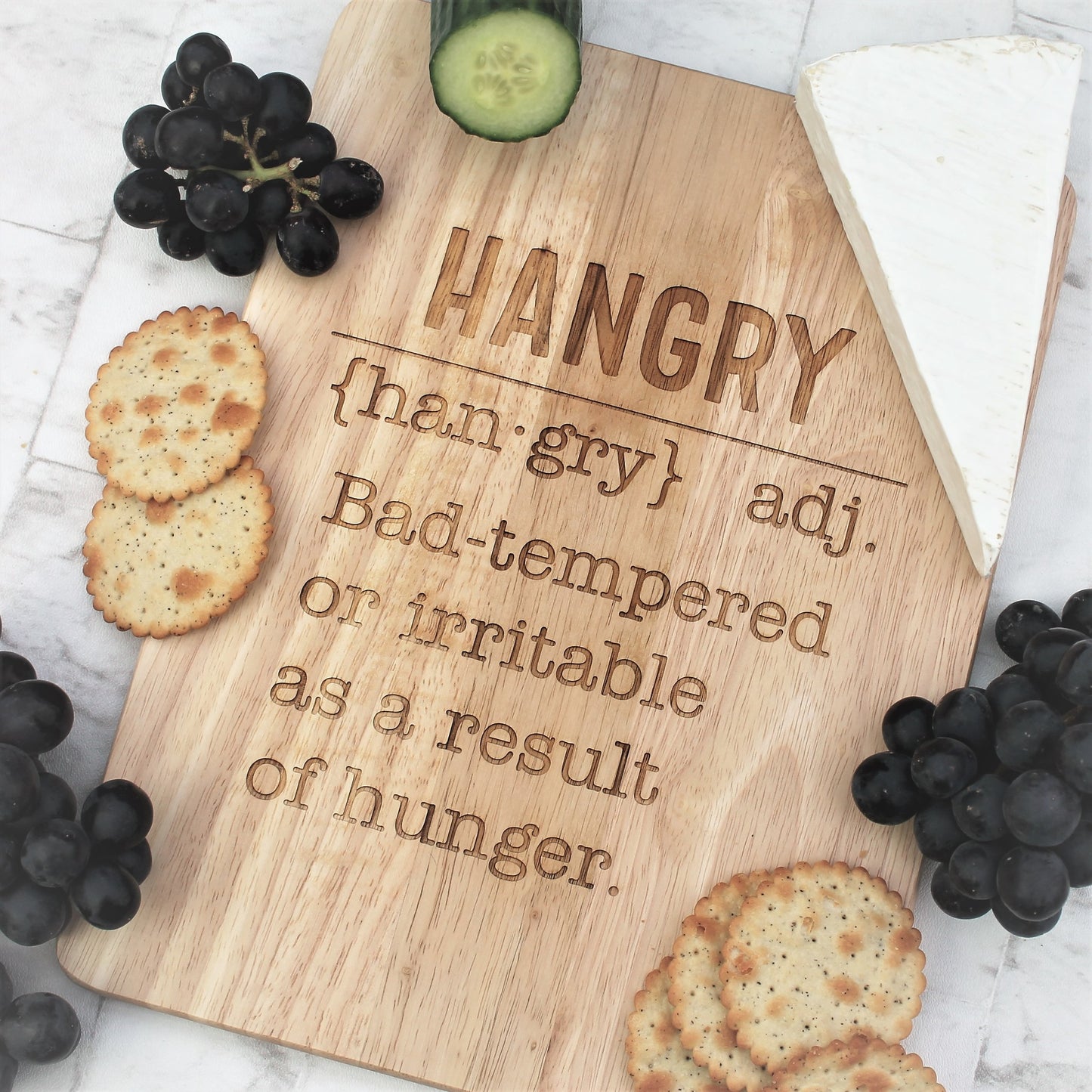 Engraved wooden chopping board with the definition of hangry on it 