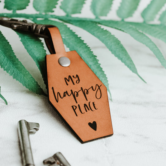 my happy place engraved onto a whisky coloured leather keyring with a heart motif.  