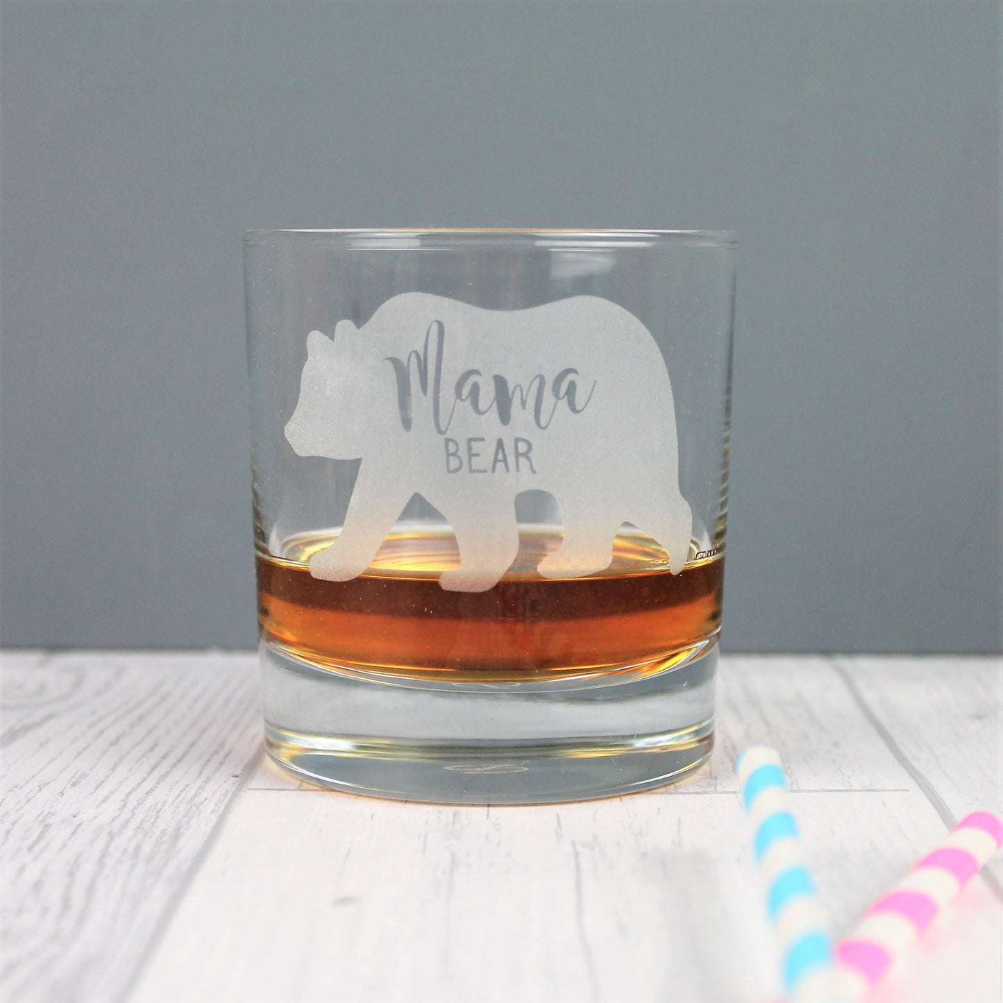 Engraved bear glass whisky tumbler with the words mama bear inside.
