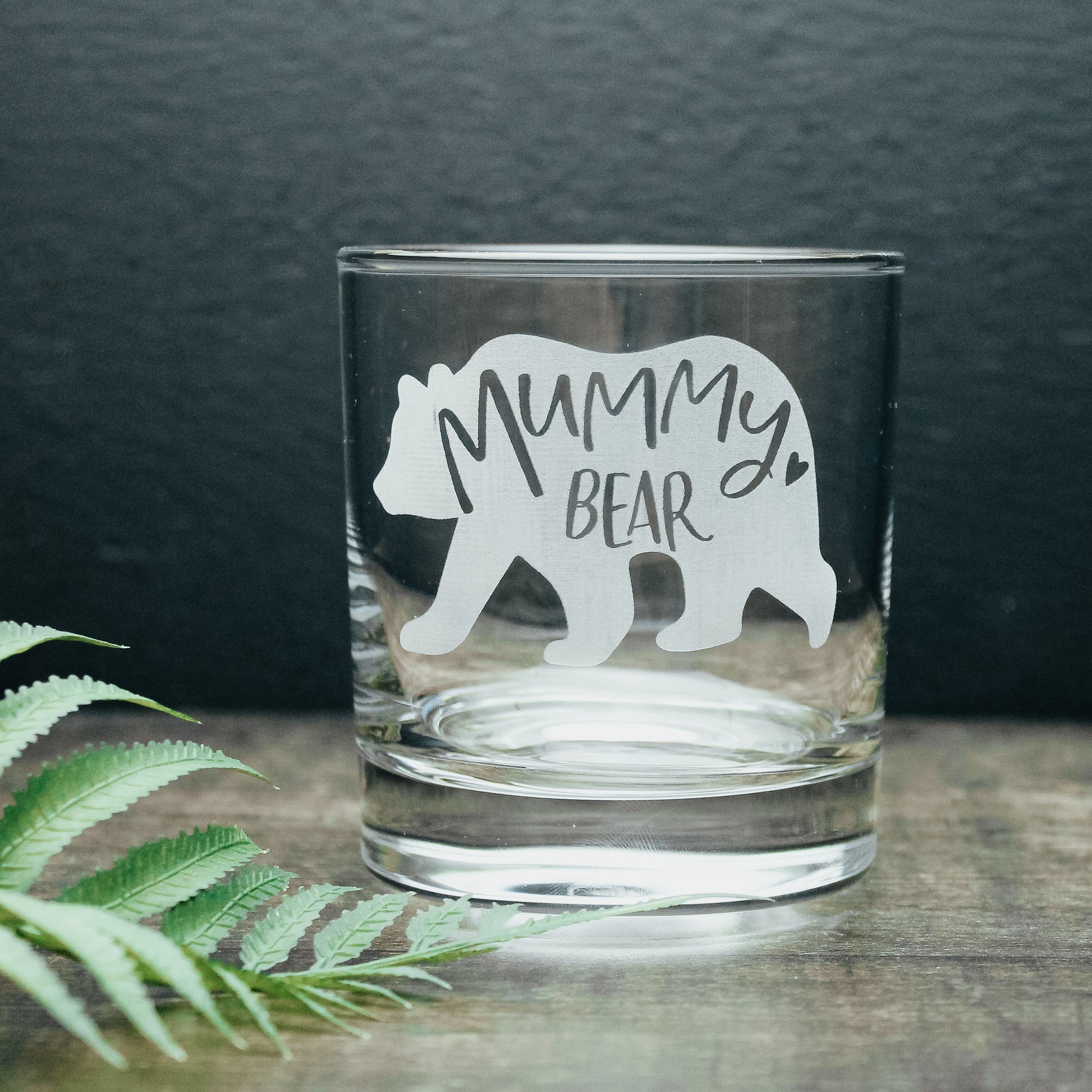 Glass tumbler with a white engraved bear design with the words mummy bear engraved on the inside of it