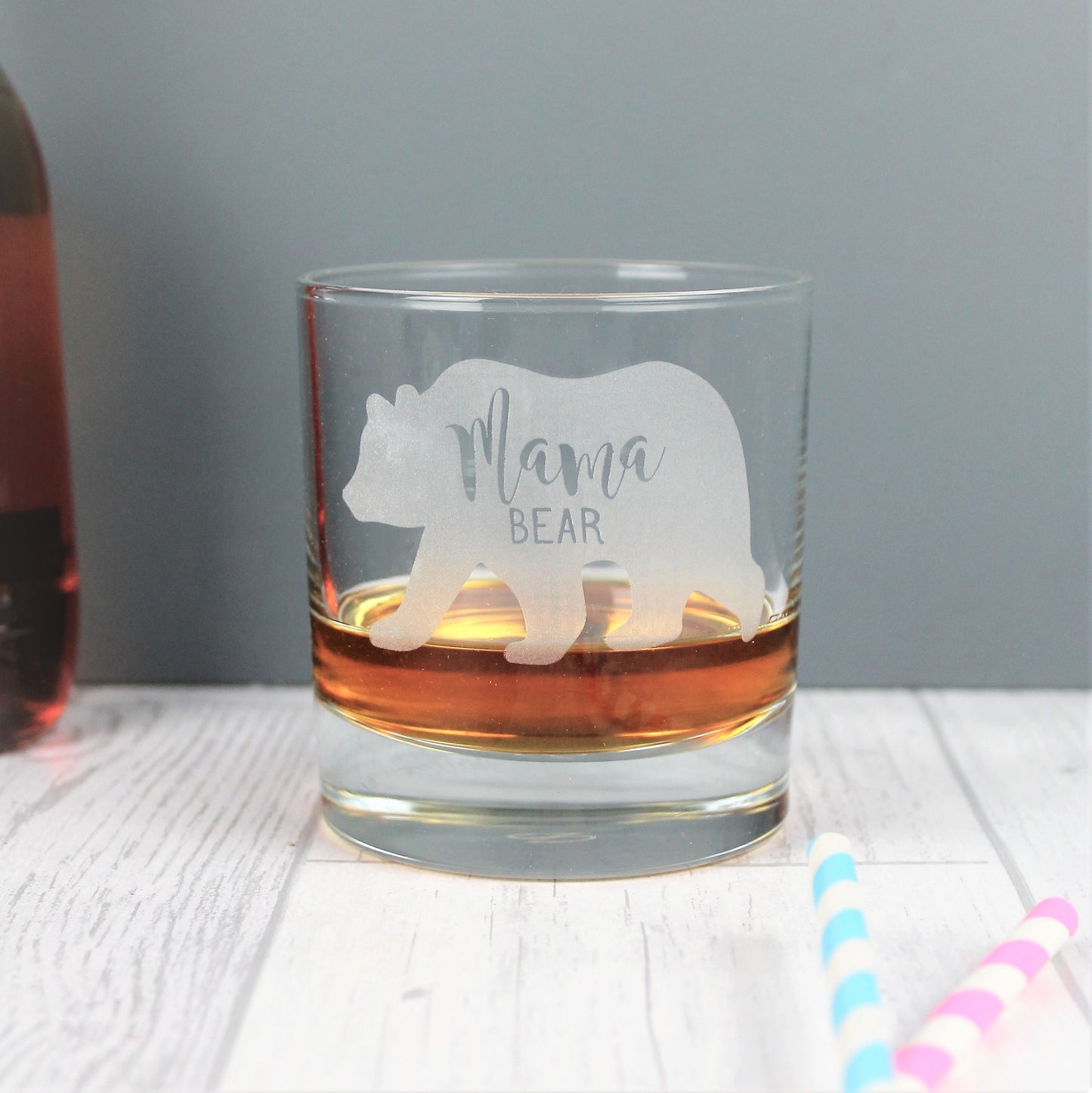 Glass whisky tumbler with the words mama bear engraved into the shape of a bear 