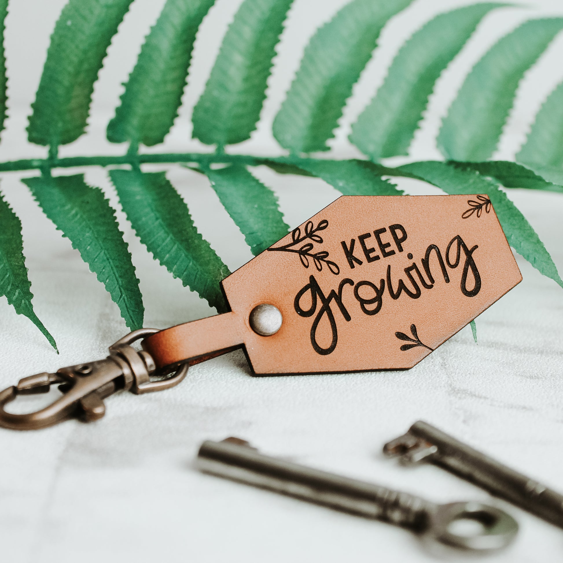 keep growing motivational positive affirmation keyring made from real leather with botanical design 