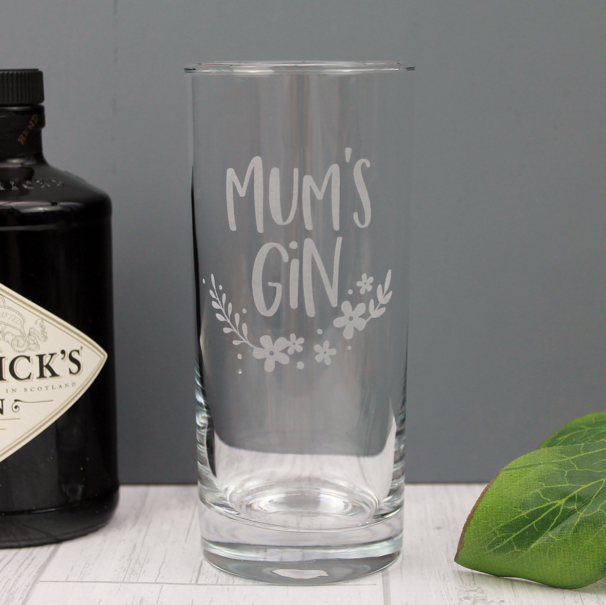 Engraved tall gin glass, with the words Mum's gin and a floral design 