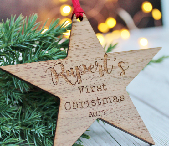 wooden engraved star Christmas tree decoration for a baby's first Christmas. Engraved with name and  year