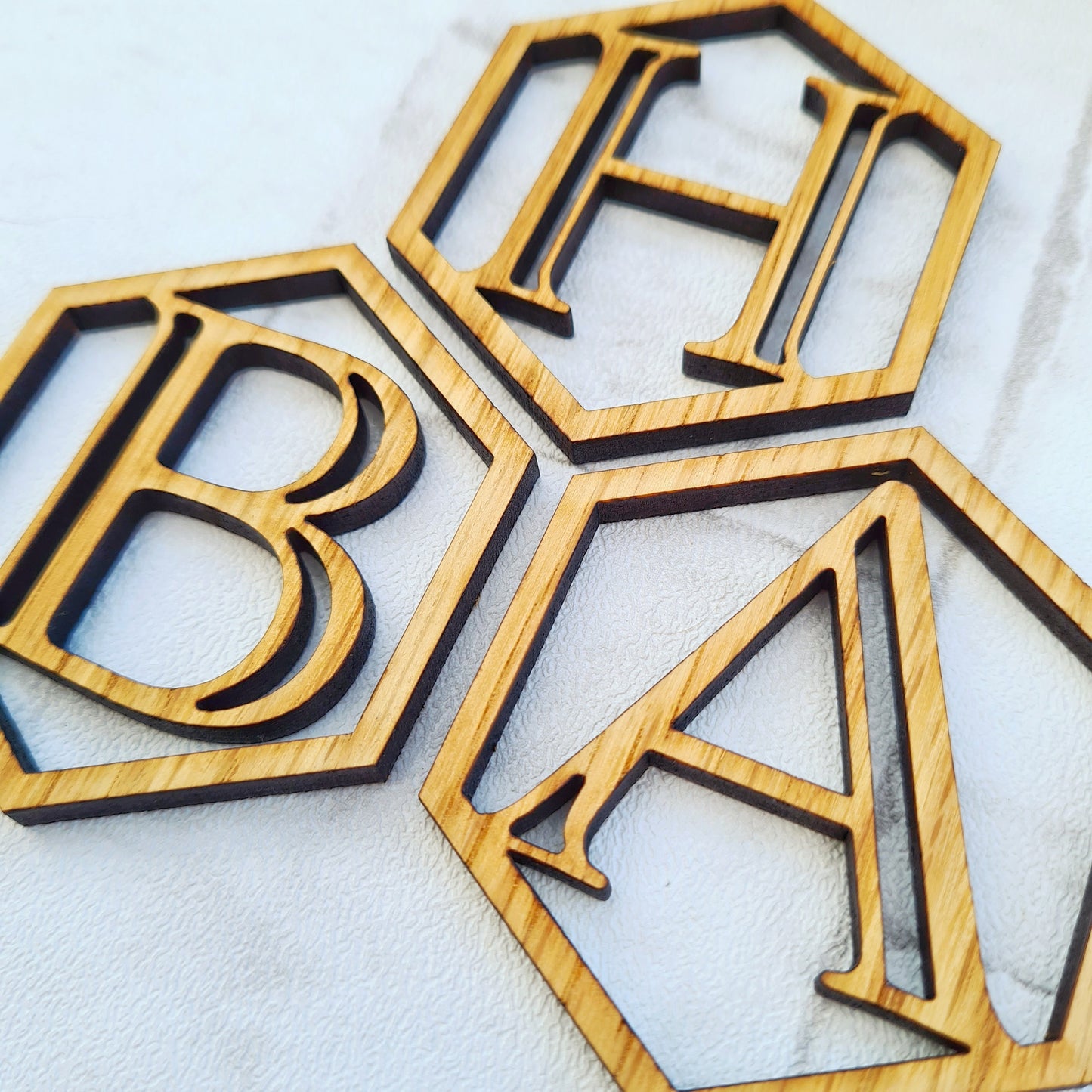 Monogrammed initial gift tag made from wood. Luxury Christmas gift wrapping idea to make Christmas extra special  