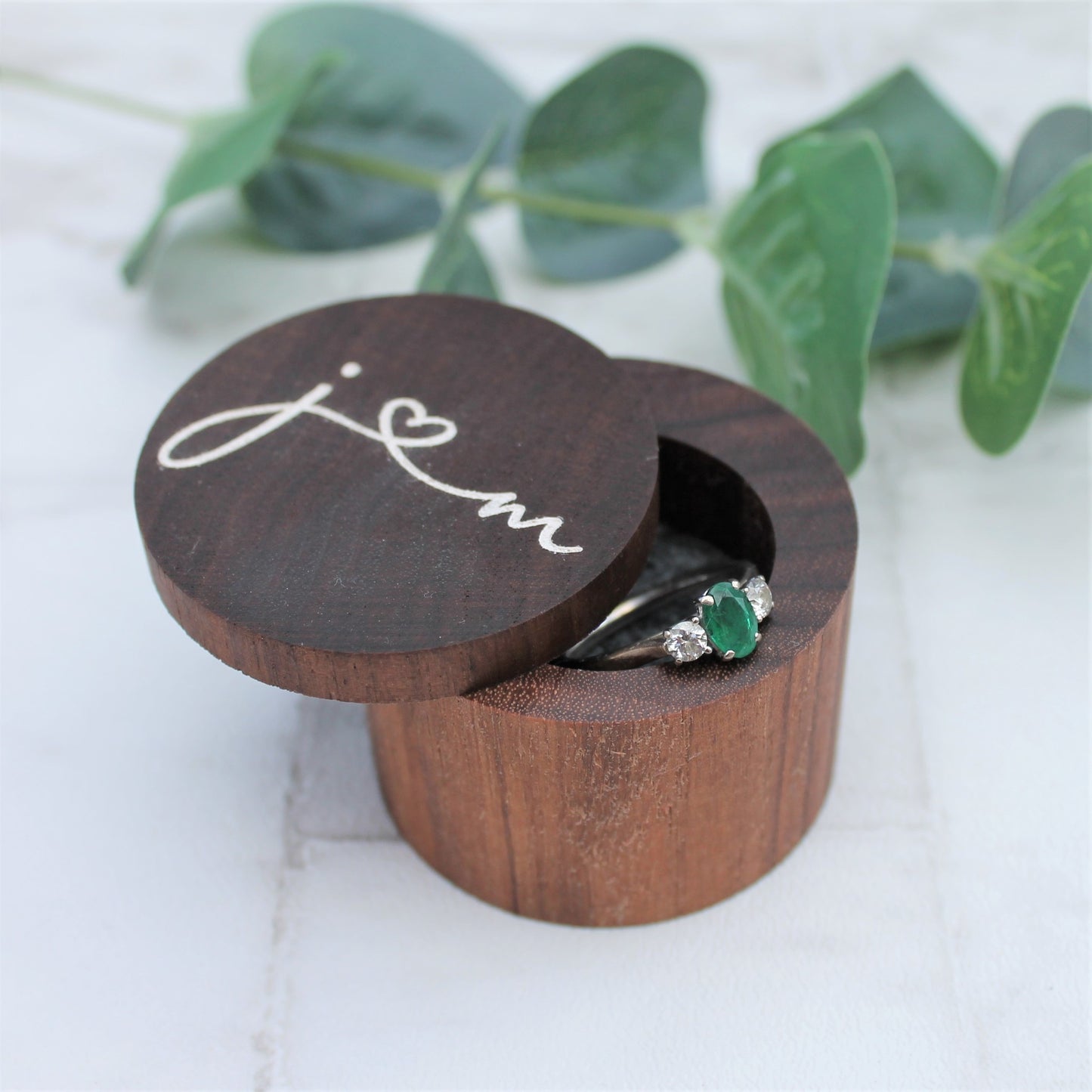 calligraphy style initials on top of a walnut ring box ideal wedding ring holder