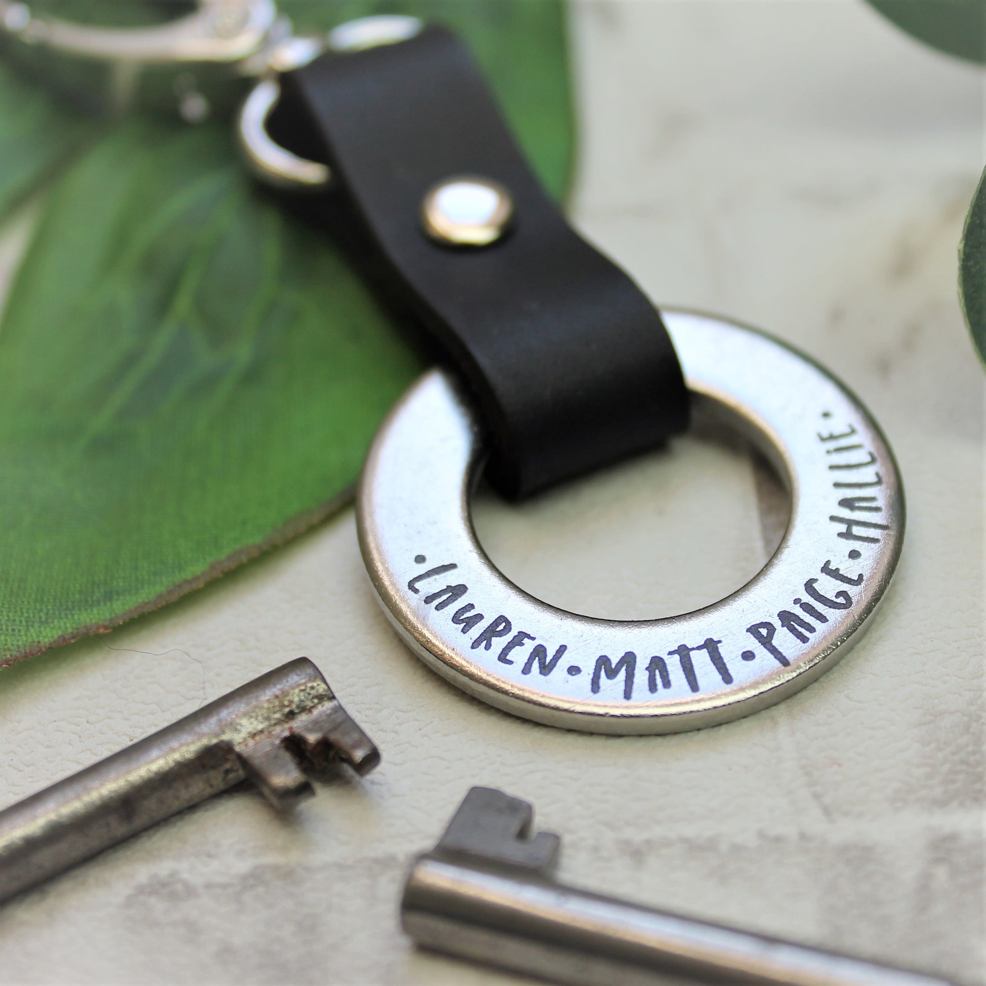 Personalised kids names keyring made from steel and black leather 