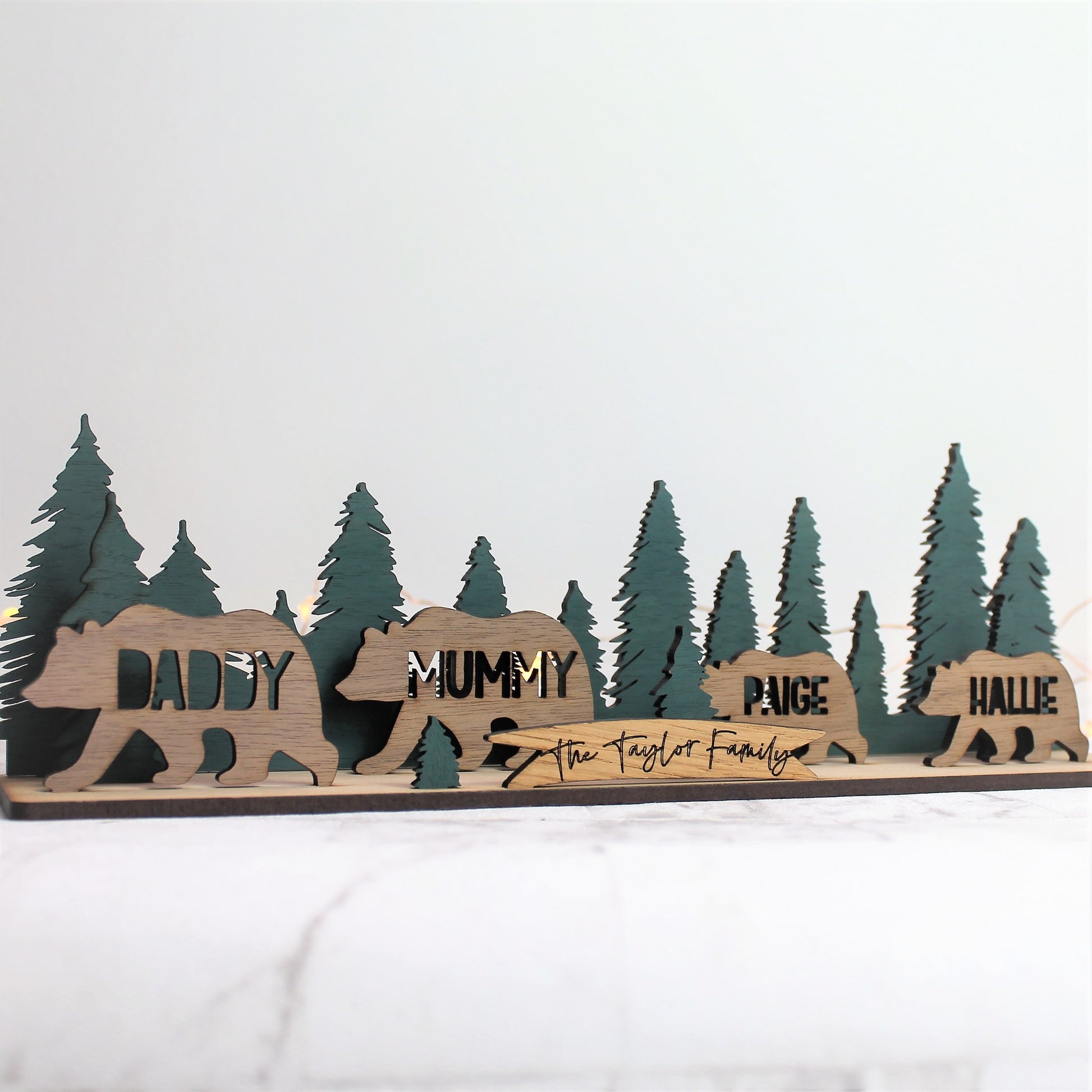 wooden festive scene with bear, forest and personalised surname sign 