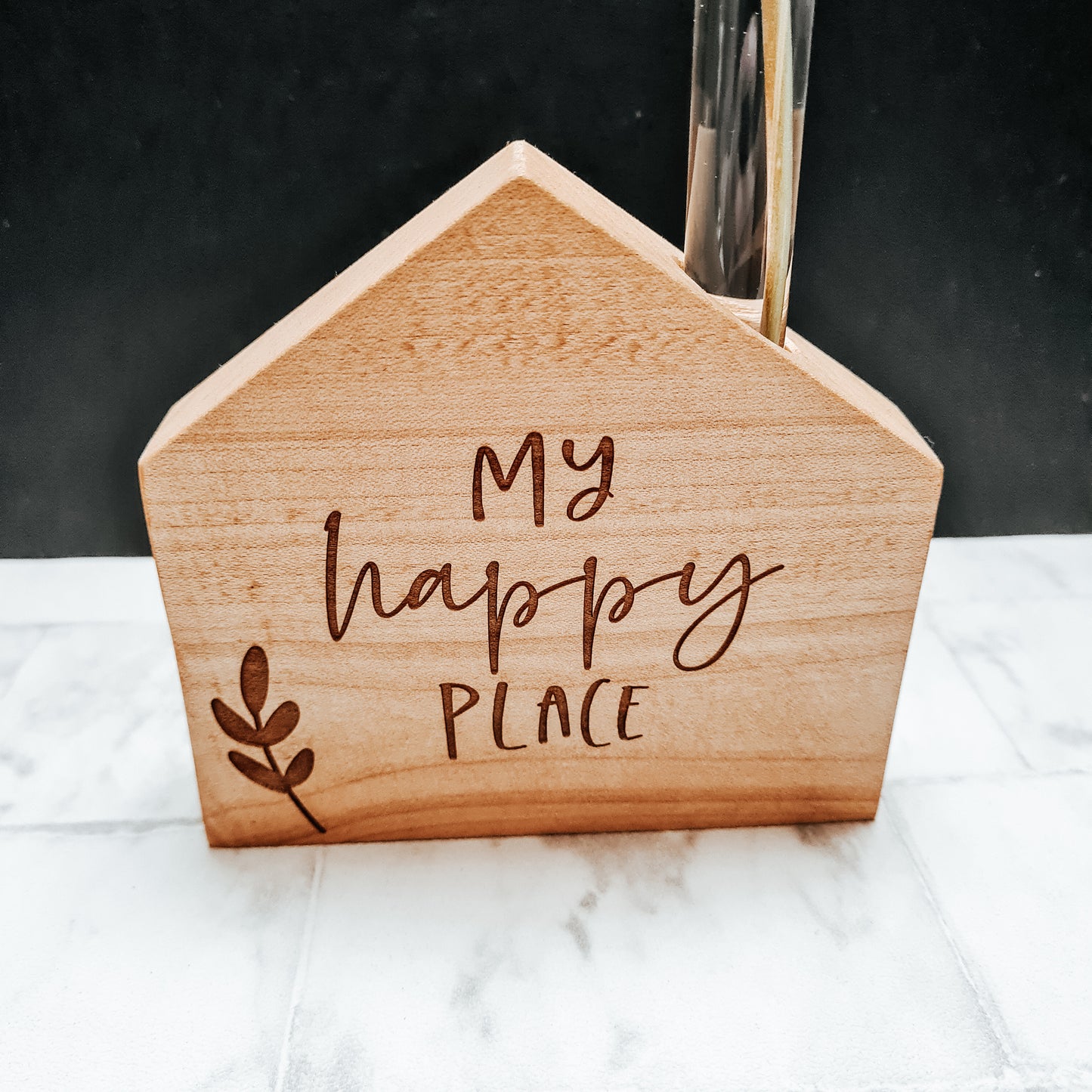 close up of my happy place wooden engraved vase 