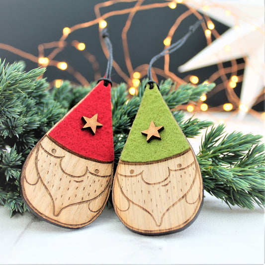 Set of 2 nisse / gnome baubles. With green and red hats with a star decoration. Made from wood and felt
