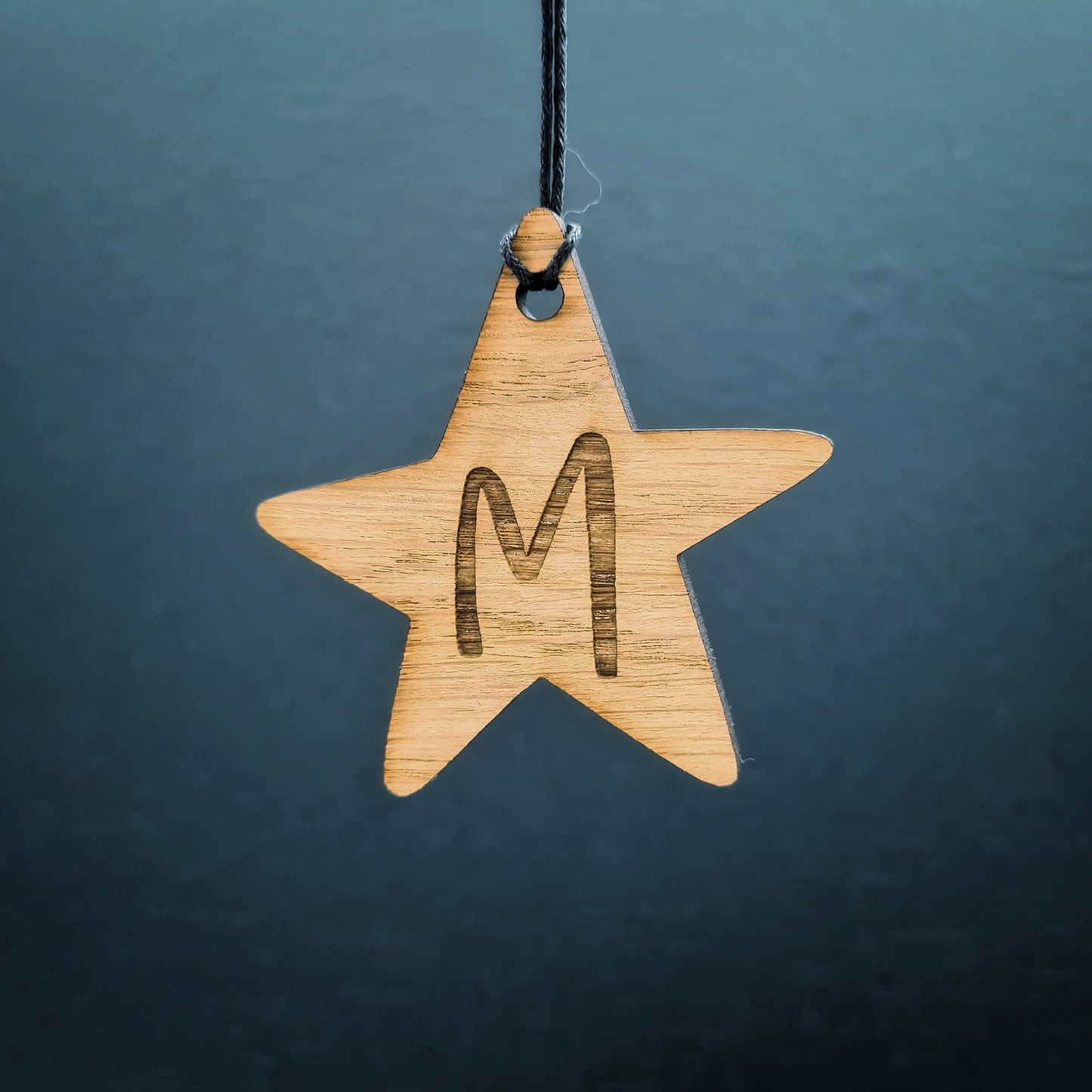 Christmas star shaped personalised gift tag. Made from wood and engraved with the initial of your choice