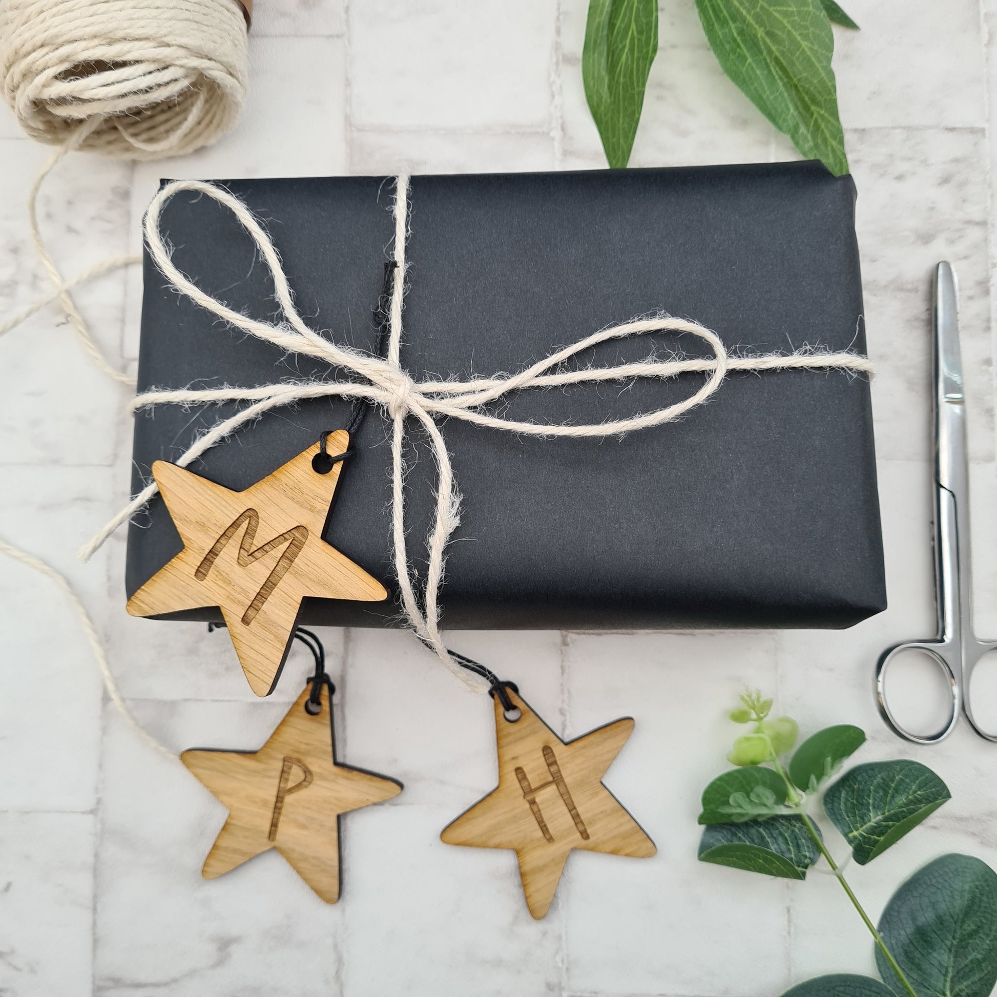 Personalised star shaped gift tag, made from wood and engraved with the initial of your choice