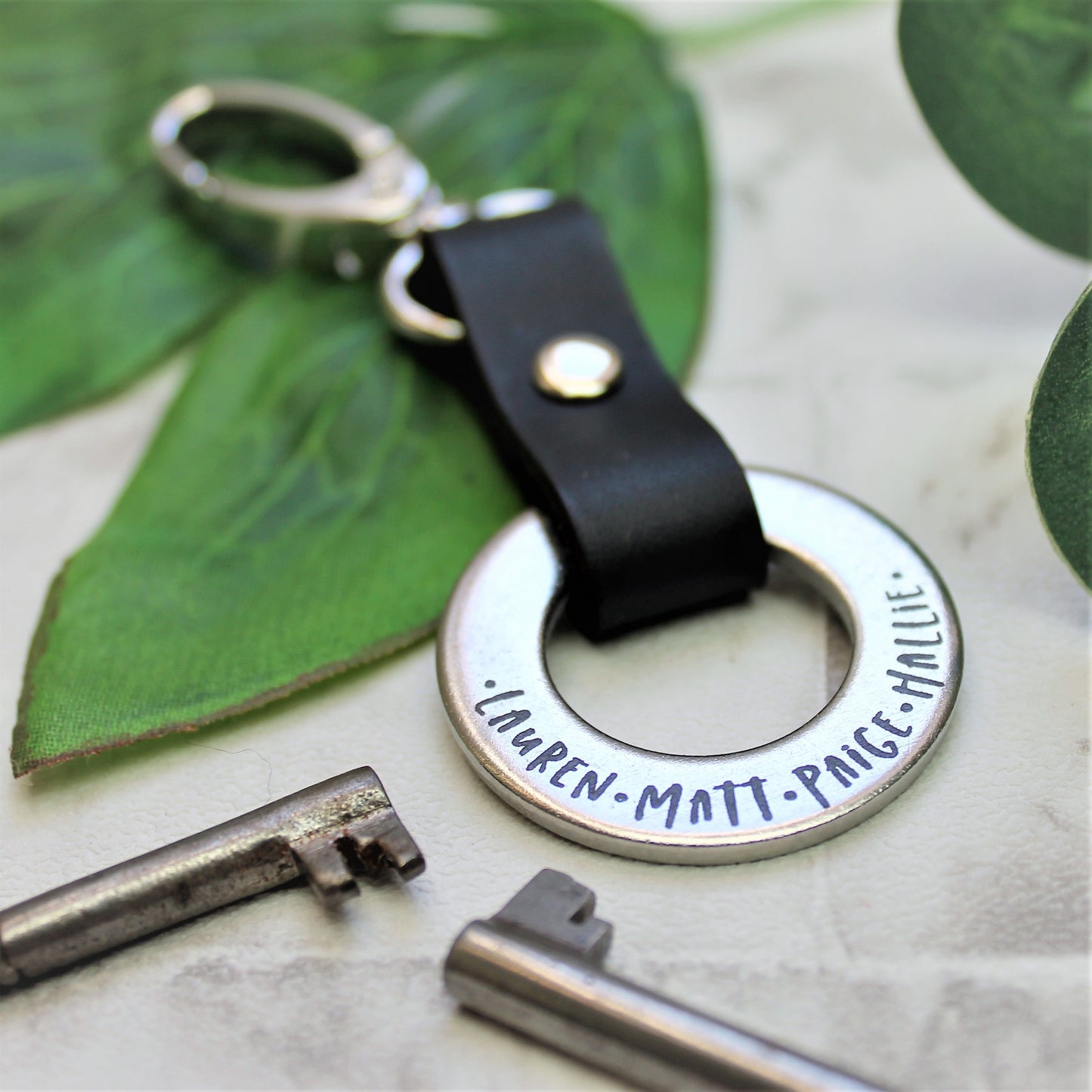Steel ring and black leather keyring personalised with family names 