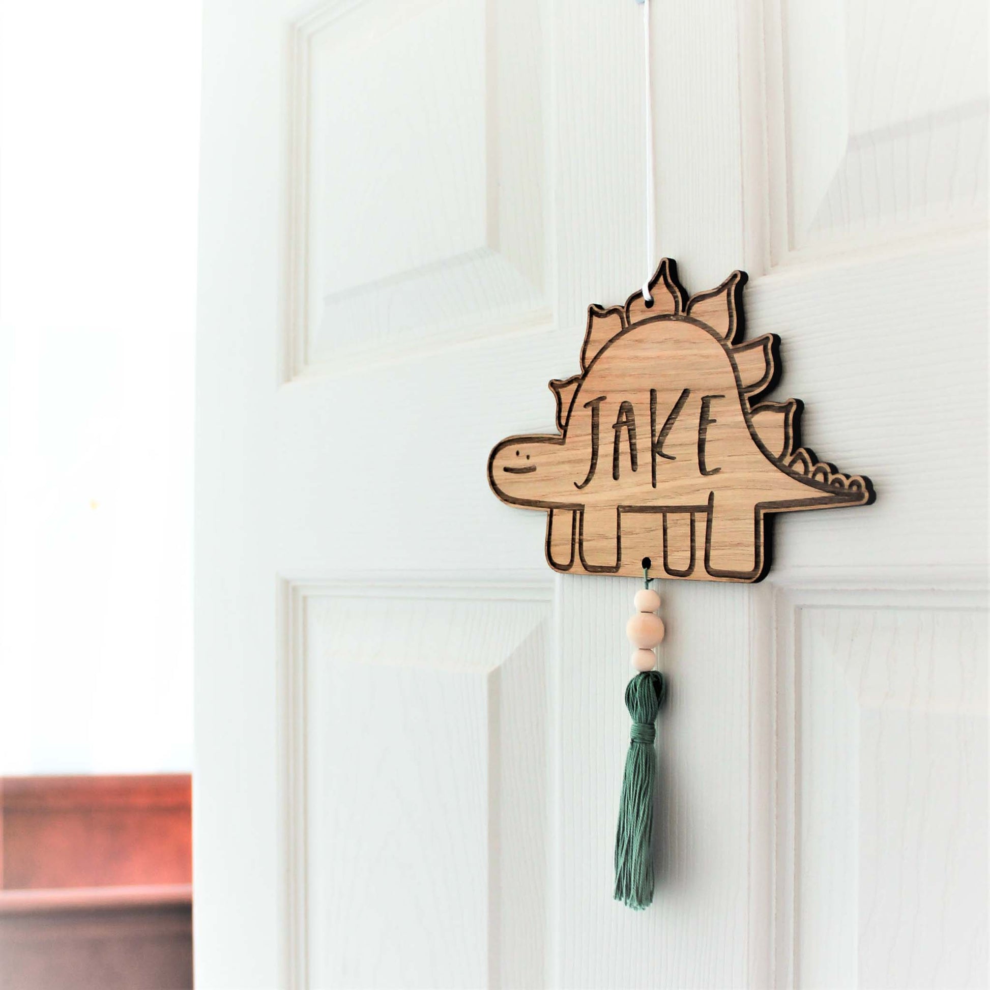 personalised wooden engraved dinsaur room sign with custom name of your choice with coloured tassel