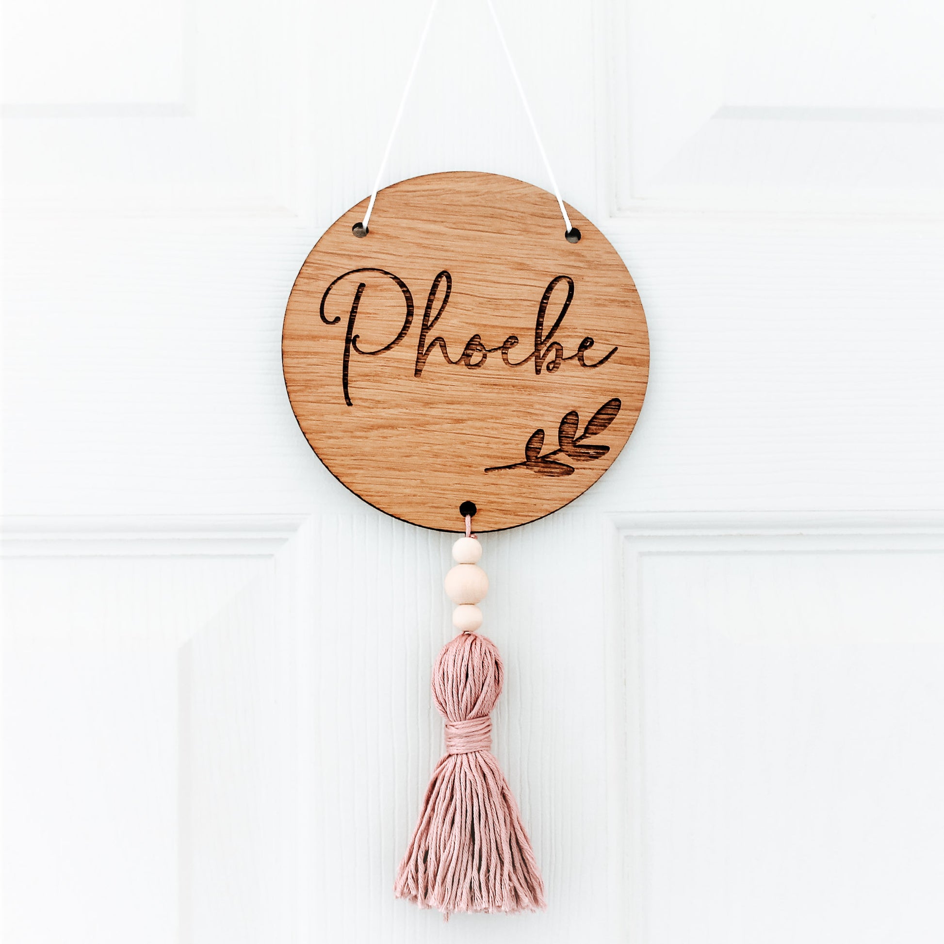 personalised round wooden sign with name, comes with coloured tassel 