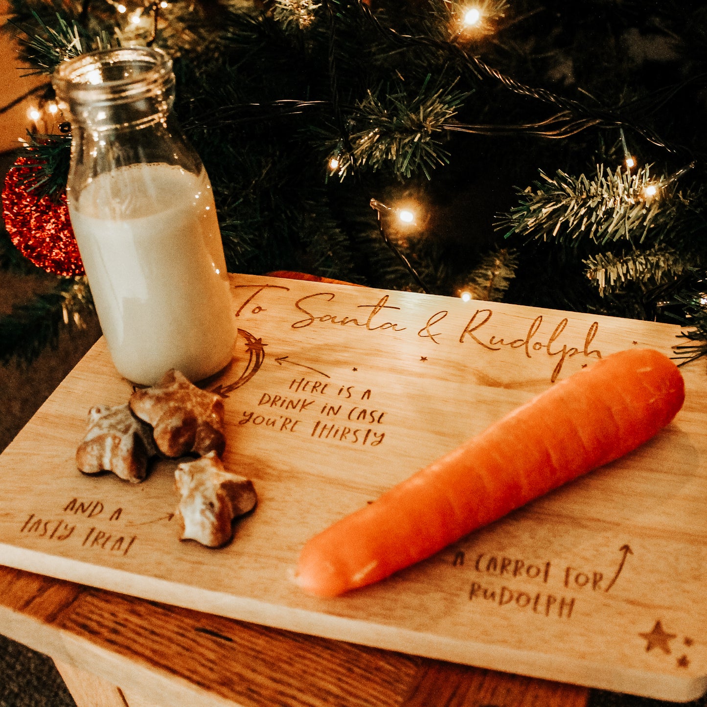 wooden christmas eve plate for santa and the reindeer with space for a drink, carrots for the reindeer and a tasty treat